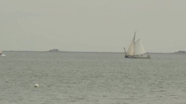 Sailboat, cargo ship and motor boat sail on the sea.slow motion.North Sea in Germany. Movement on the water. 4k footage