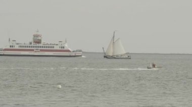 Water transport. Sailboat, cargo ship and motor boat sail on the sea.North Sea in Germany. Movement on the water. 4k footage