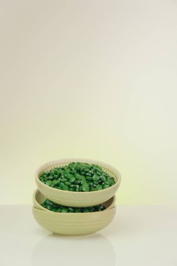 Spirulina pills in a round green cups set with reflection.Vitamins and dietary supplements.Spirulina algae tablets.Super food.Food supplements for a healthy lifestyle