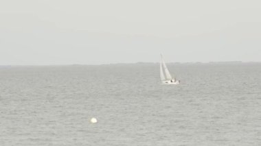 White sailboat in the sea. Ship in sea voyage. light key.Sea voyages and adventures. Vacation at sea. 4k footage