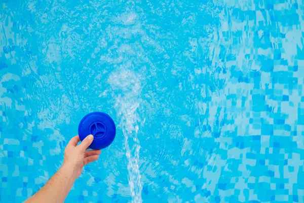 Swimming pool Filter. cleaning filter with chlorine tablets into the blue water of the pool.Swimming pool cleaning.