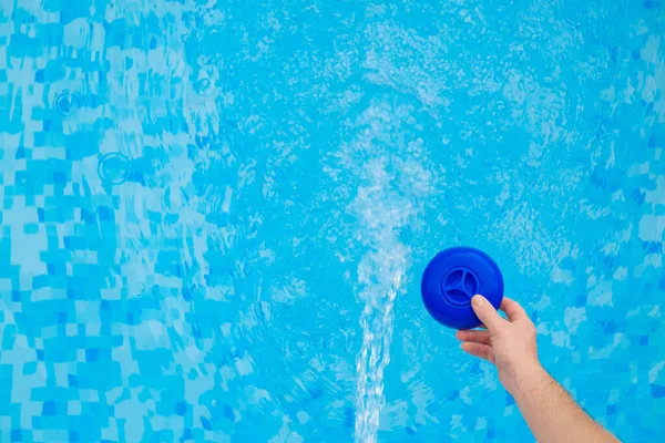 Pool water filtration. filter with chlorine tablets into the blue water of the pool.Swimming pool cleaning.