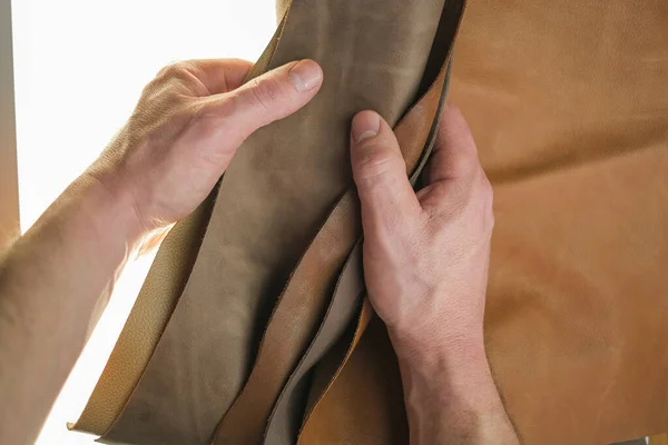 白い背景に男性の手にセット本革の作品革素材の選択 本革の品揃え 茶色本革の品揃え — ストック写真