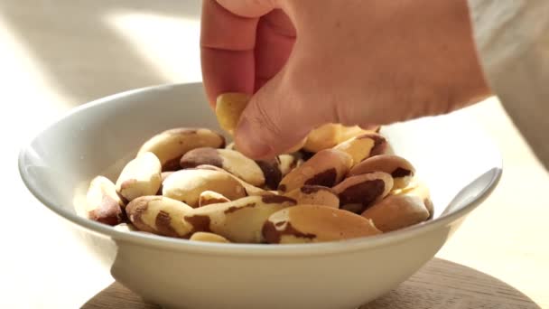 Hand Takes Brazil Nuts Plate Slow Motion Healthy Fats Brazil — Stock Video