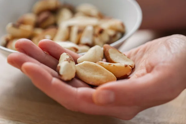 Brazil nuts in hand.Healthy fats.Brazil nuts in the diet.Nuts and seeds. Keto diet ingredient.Useful healthy snack.