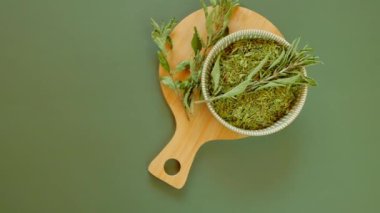 Diyet tatlandırıcı. Ezilmiş stevia yeşil bir arka planda bardak bırakır. Stevia bitkisi. Alternatif düşük kalorili sebze tatlandırıcı. 4k görüntü