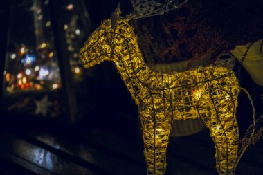 Noel Ren Geyiği. Kış karlı bir sokakta parlayan elektrik dekorasyonu. Açık hava dekorasyonları. Avrupa 'da Noel