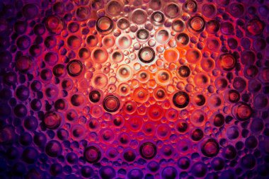 Mor, pembe ve siyah tonlarda Gradyan Dokuya sahip kabarcıklar. Çemberlerle parıldayan arka plan. Işık yanıp sönen koyu yuvarlak desenli arka plan.. 