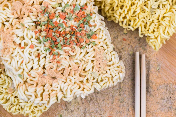 Fast food, chinese raw noodles with spices on the wooden background