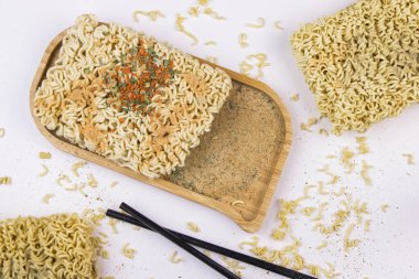 Fast food, chinese noodles with spices on the wooden background