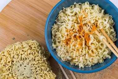 Fast food, chinese noodles with spices on the wooden background