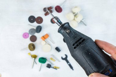 Dremel rotary kit, dremel heads, instrument for handwork on gray background