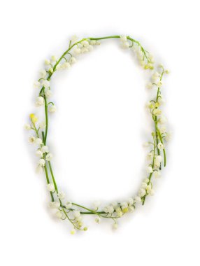 Letter O of white flowers Lily of the valley ( Convallaria ) on a white background. Top view, flat lay