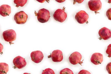 Fresh red pomegranate garnets on white background with space for text. Top view, flat lay