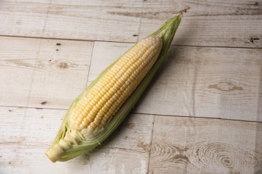 Corn on wooden background, healthy vegetable, food, on wooden background