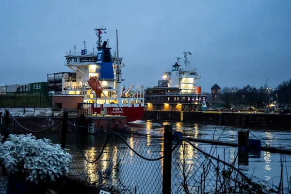 stock image Kiel, Germany - February 22, 2022: A maritime vessel in nighttime is entering the Kiel Canal from the Baltic Sea. The Kiel Canal links the Baltic Sea with the North Sea