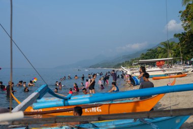 Laiya Plajı, 17 Ağustos 2024: İnsanlar muson mevsiminde bile yüzmekten zevk alır. Batangas Bölgesi, Filipin