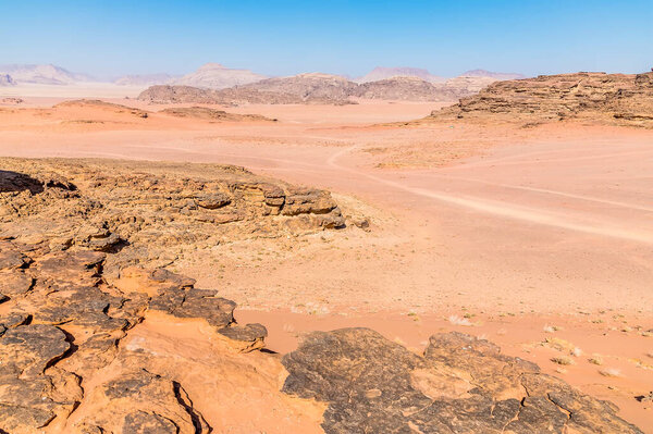 A view of the trial across the desert landscape in Wadi Rum, Jordan in summertime