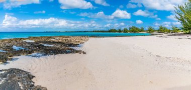A panorama view across a deserted bay on the island of Eleuthera, Bahamas on a bright sunny day