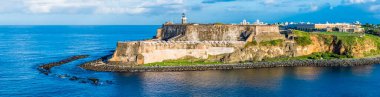 A panorama view over the fortifications at the harbour entrance in San Juan, Puerto Rico on a bright sunny day