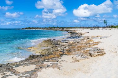 A view along a rocky shoreline on the island of Grand Turk on a bright sunny morning