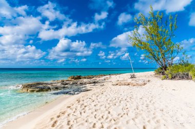 A view along the shoreline towards a rocky headland on the island of Grand Turk on a bright sunny morning