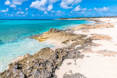 A view down a rocky shoreline of a bay on the island of Grand Turk on a bright sunny morning