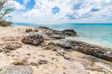 A view over a rocky headland on the shoreline of the island of Grand Turk on a bright sunny morning