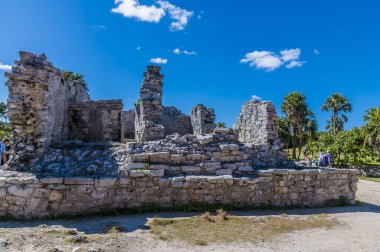 A view of ancient building ruins at the Mayan settlement of Tulum, Mexico on a sunny day