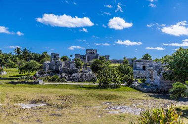 A view across the central complex at the Mayan settlement of Tulum, Mexico on a sunny day