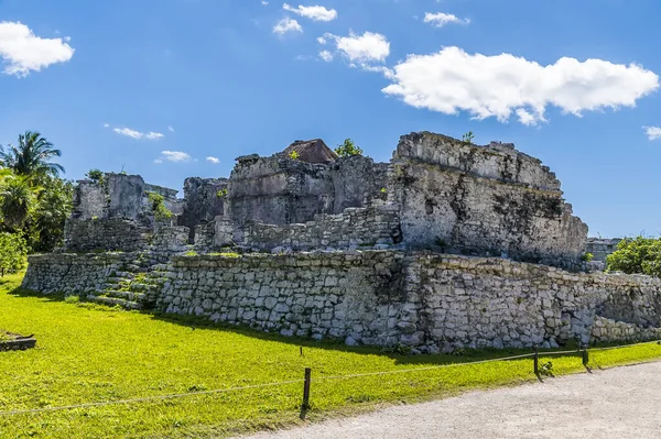 A view across palace ruins at the Mayan settlement of Tulum, Mexico on a sunny day