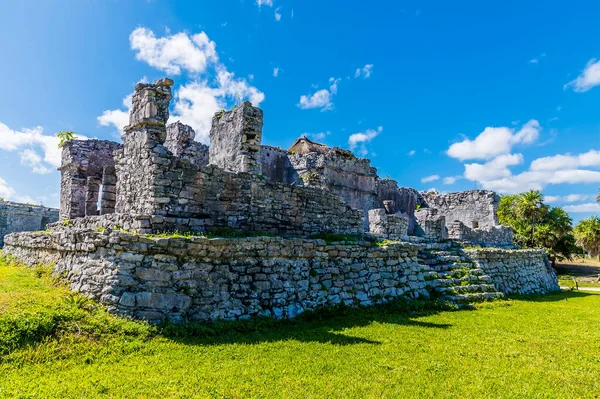 A view across a temple ruins at the Mayan settlement of Tulum, Mexico on a sunny day