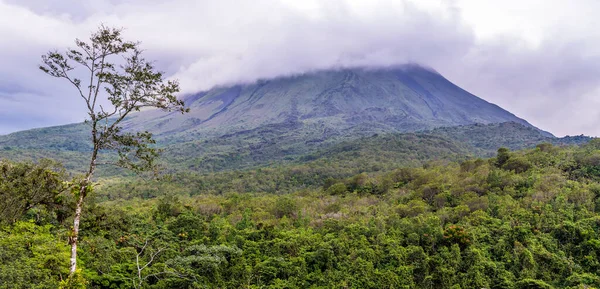 stock image A view up the side of  the cloud covered Arenal volcano, Costa Rica in the dry season