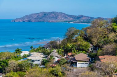 Kurak mevsimde Kosta Rika 'daki körfeze doğru Tamarindo tatil beldesi boyunca bir manzara.