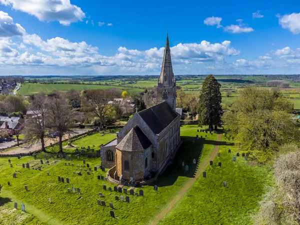 An aerial view over the Anglo Saxon church and surroundings in the village of Brixworth, Northamptonshire, UK in summertime