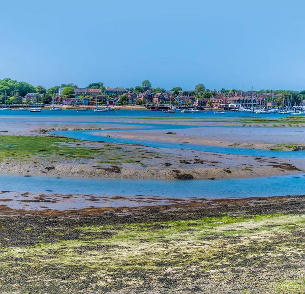 A view of tidal mud flats exposed at low tide on the River Hamble, Hampshire in summertime