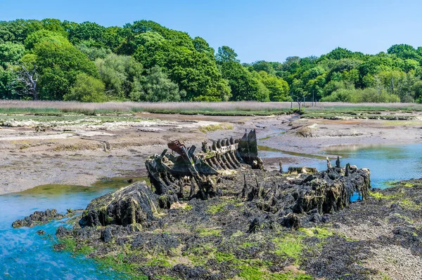 A view over a wreck at low tide on the River Hamble, Hampshire in summertime