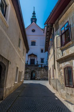 Slovenya 'nın Skofja Loka kentindeki Capuchin Köprüsü' nden yaz mevsiminde dar bir sokağa açılan manzara