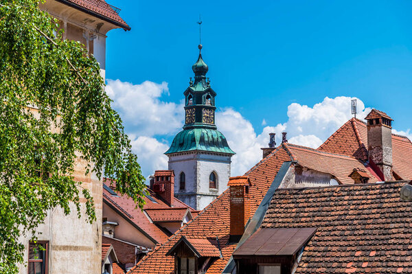 A view towards the cathedral tower in the old town of Skofja Loka, Slovenia in summertime