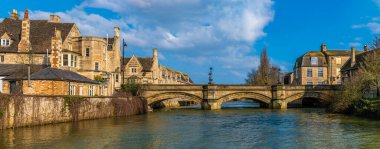 A view along the River Welland towards Stamford Bridge in Stamford, Lincolnshire, UK in springtime clipart