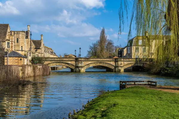 A view down the Riverside Park beside the River Welland towards Stamford Bridge in Stamford, Lincolnshire, UK in springtime