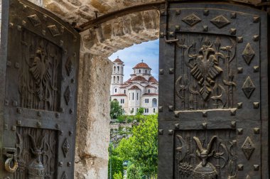 A view from door to the Skanderbeg memorial towards the Orthodox church in Lezhe, Albania in summertime clipart