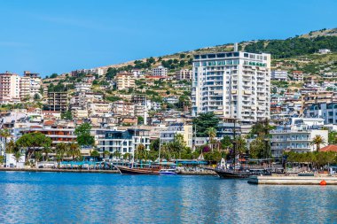 Yazın sabah Sarande 'deki körfezin yanındaki binalara bakan bir manzara.