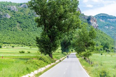 A view down a road in the Gjere mountains, Albania in summertime clipart