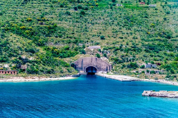 stock image A view towards a disused submarine bunker from Palermo Beach on the road to Sarandra, Albania in summertime