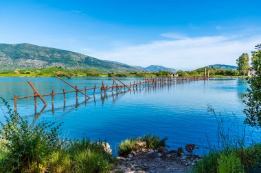 Arnavutluk 'un Butrint kentindeki antik kalıntıların yanındaki tatlı su gölünde yaz mevsiminde bir baraj manzarası