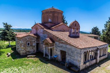 A view of Saint Marys church beside the Roman ruins of Apollonia in Albania in summertime clipart