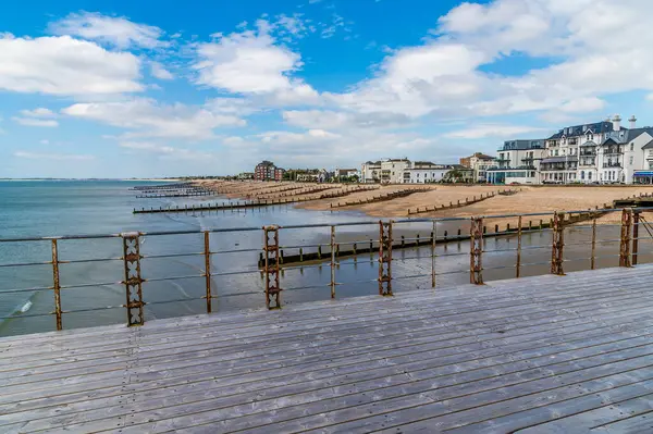 stock image A view westward past the pier railings along the beach at Bognor Regis, Sussex in summertime