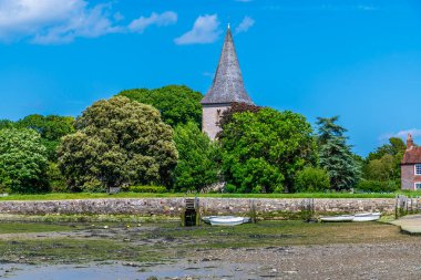 Yaz mevsiminde Batı Sussex, Bosham 'daki kiliseye doğru rıhtım manzaralı bir manzara.