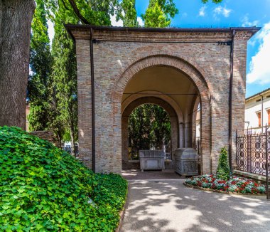 A view towards the Four Arches of Strongarm mausoleum in Ravenna, Italy in summertime clipart